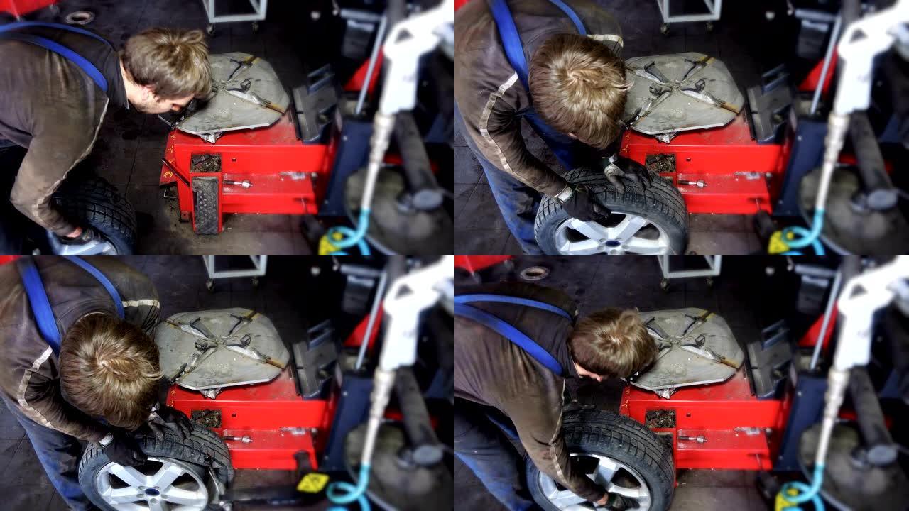 工人从车轮上卸下轮胎。