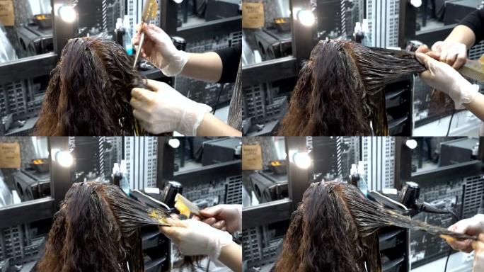 特写，发型师-美发师在美容院为女孩的头发涂漆，并用刷子在上面涂漆。头发护理。从顶部后部看到的景色。4