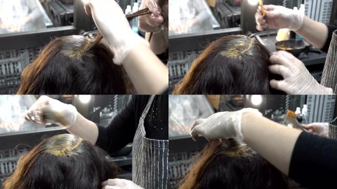 美发师-发型师在美容院为女孩的头发涂漆，并使其涂成棕色。头发护理。特写。从顶部后部看到的景色。4K。