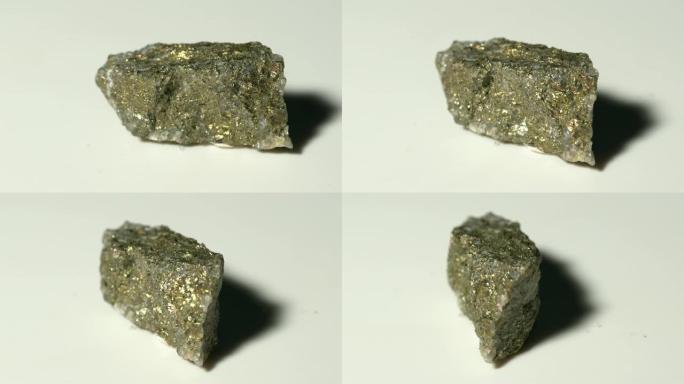 白色背景旋转的黄铜矿矿物样品