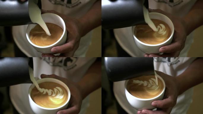 在酒吧关闭咖啡师手工制作咖啡艺术。如何用热牛奶制作咖啡艺术，将蒸牛奶倒入咖啡中进行咖啡艺术。工业食品