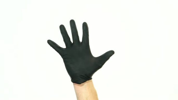 男人的手在黑色橡胶手套中纹身的动作。