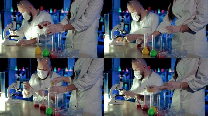 液体从烧瓶中倒入透明烧杯中。化学实验。科学家化学家通过显微镜观察。