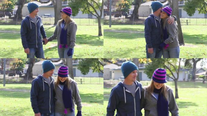秋季夫妇在公园散步和亲吻