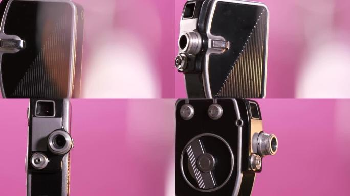 粉红色背景上的微型复古8毫米电影相机