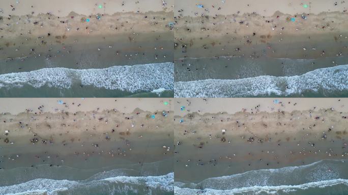 海南省三亚市三亚湾耶梦长廊沙滩上的游客