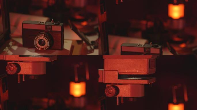 复古35毫米相机和放大镜在红色摄影暗室特写