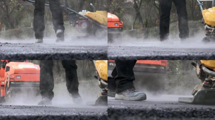 一队工人用铁锹穿着防护服，将热沥青放在街道道路建设工人上。在炎热的天气里工作。
