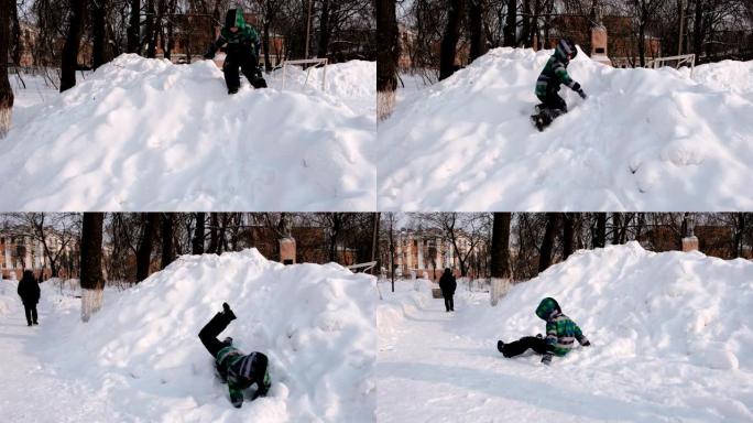 男孩在雪地里玩耍。从雪山上下颠倒地滑落。
