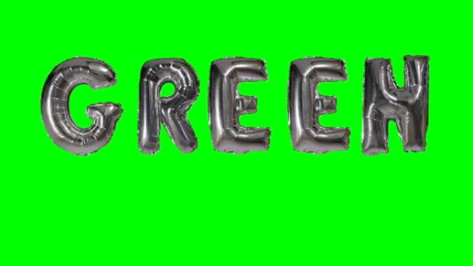 漂浮在绿色屏幕上的氦银气球字母中的绿色单词