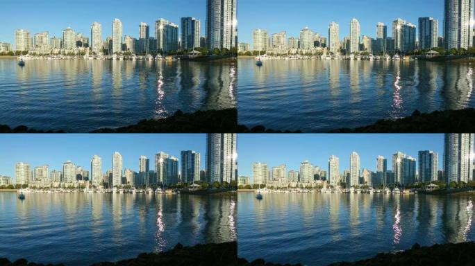 福溪码头的豪华高层公寓楼和船只。加拿大不列颠哥伦比亚省温哥华海滨天际线