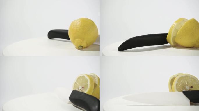 黄色柠檬和小刀放在白色木桌上，旋转360度。白色背景。