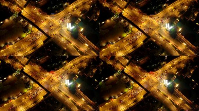 高速公路交叉口鸟瞰图形状字母x十字在晚上。交通概念中的桥梁、道路或街道。马来西亚吉隆坡市中心城市建筑