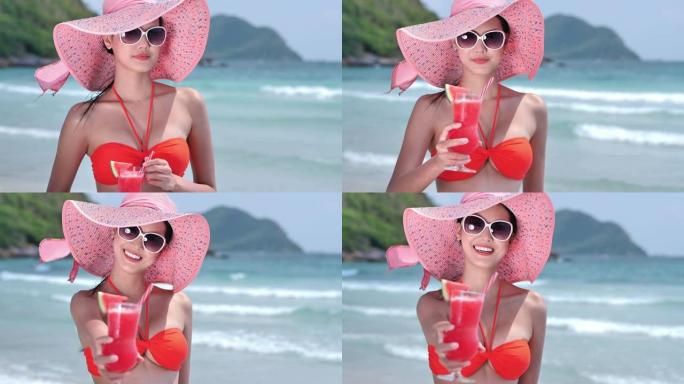 美丽的年轻亚洲女性，穿着比基尼和果汁，在海上放松。概念生活方式，旅游。慢动作