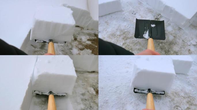 男人从小路上铲雪。暴风雪后用雪铲从人行道上除雪。雪块。