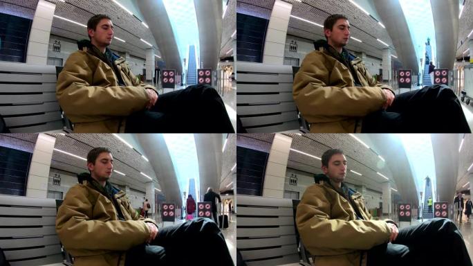 年轻的成年男子在机场延时睡觉