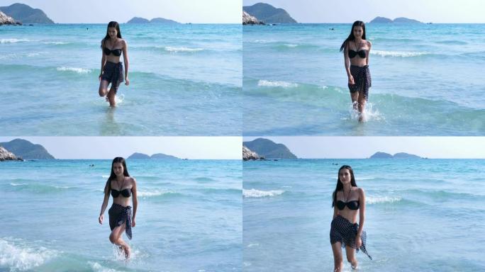 美丽的年轻亚洲女子在比基尼快乐，微笑，享受散步。在海上度假放松。概念生活方式、旅游、度假