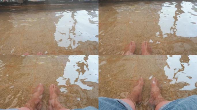 人体腿部浸泡在自然界的温泉中的特写镜头