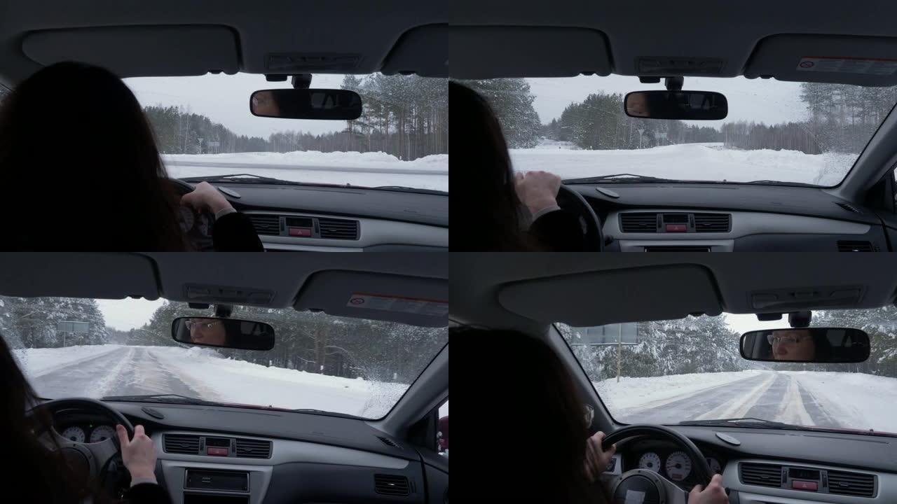从后座看冬季白天在十字路口和雪路上开车的女人
