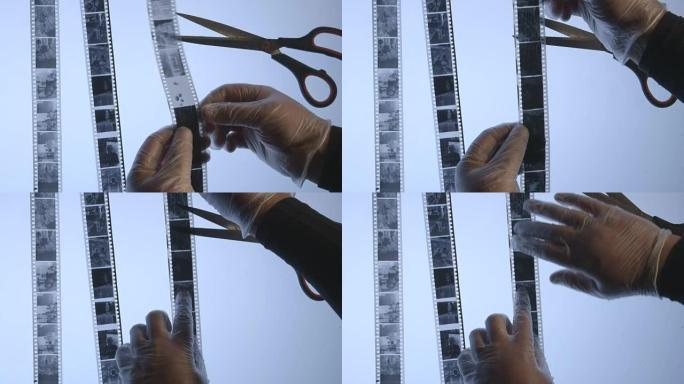 摄影师在黑暗的房间里检查35毫米黑白胶片底片