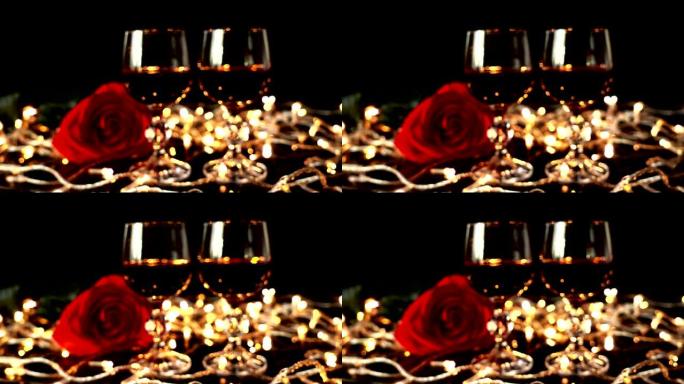 在明亮的花环的背景下，酒杯和玫瑰。注意力不集中。