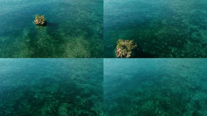 令人惊叹的空中无人机图像，描绘了一个五颜六色的海底礁石，在平静的天气中，平坦的海面和令人难以置信的五