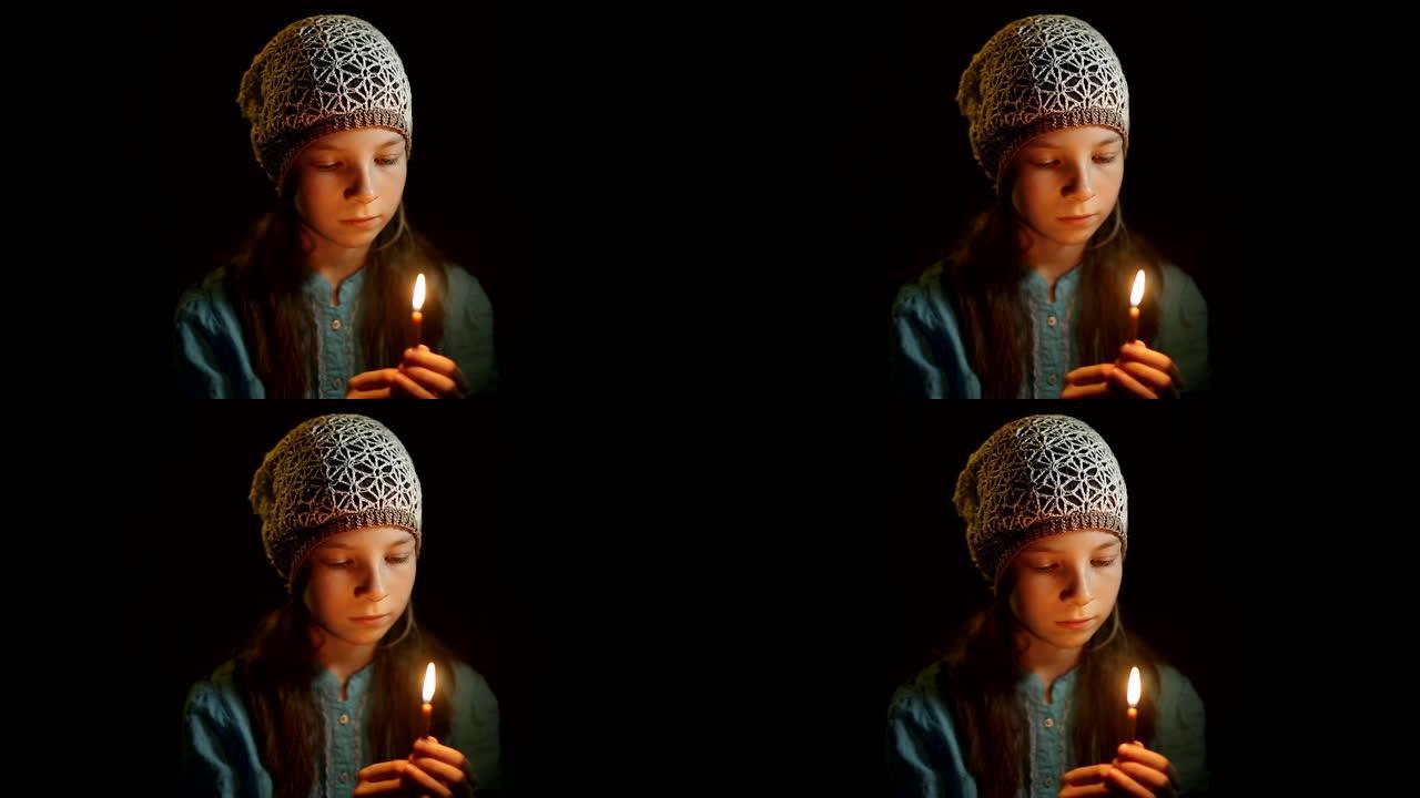 小女孩在黑暗的房间里祈祷