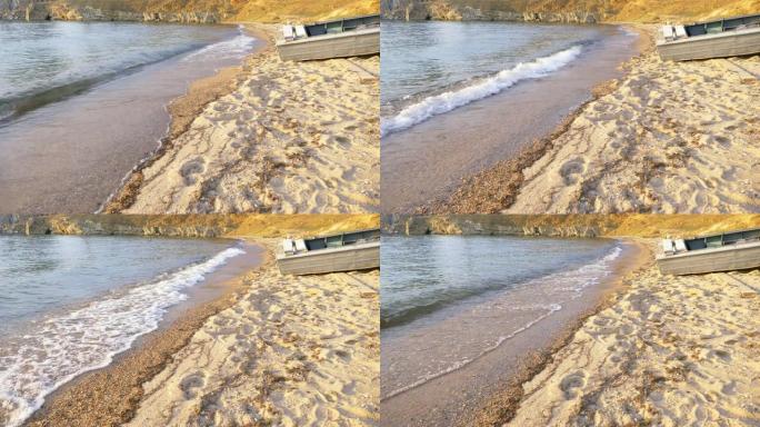 俄罗斯伊尔库茨克奥尔洪岛的沙滩和木船上的水浪冲浪