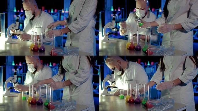 在化学实验室中进行液体分析的实验。移液器被收集到溶液中，并在显微镜反应下观察。