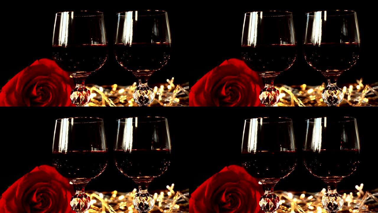 在明亮的花环的背景下，酒杯和玫瑰。