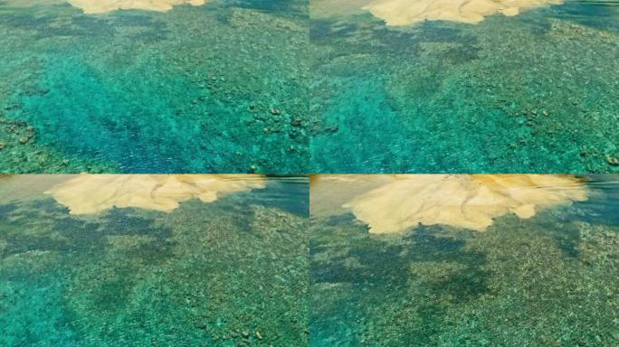 令人惊叹的空中无人机图像，大珊瑚礁在平静的天气平坦的海水和令人难以置信的五颜六色的海洋床中遇到沙滩，