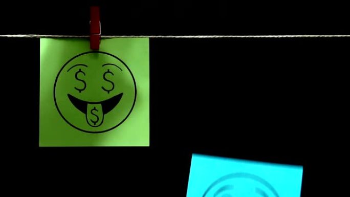 两个贴纸。的情绪。在绿色右表上的表情爱钱。在蓝色的页面上，他的脸上有一种失望和悲伤的表情。黑色背景。