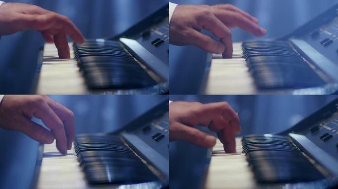 男人演奏音乐键盘。音乐家弹钢琴。在红色史诗电影相机上拍摄。
