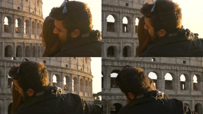 浪漫的年轻夫妇游客日落时在罗马斗兽场前做著名的泰坦尼克号场景男友抱着女朋友张开双臂