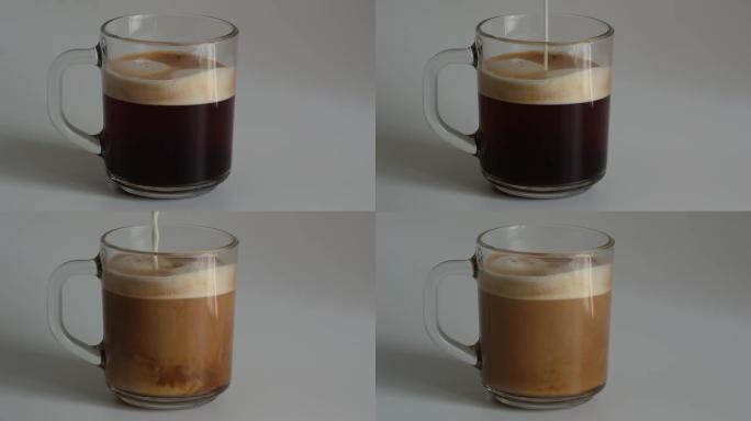 将牛奶添加到装有新鲜芬芳的黑咖啡和泡沫奶油的玻璃杯中的特写镜头