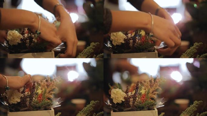 花匠以包装专业人员的形式放置植物，为庄严的活动创造设计。鲜花、花束、胸花、绿色