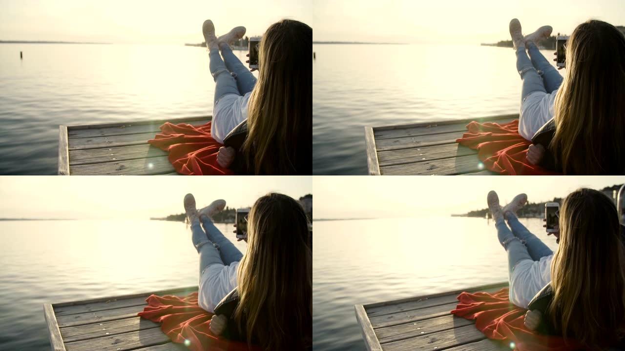 海边的女孩带着instagram的故事走向日落