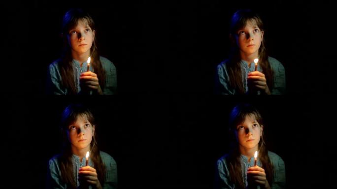 小女孩在黑暗的房间里祈祷