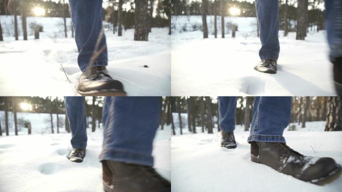 人的脚在雪地上行走的特写镜头。慢动作拍摄