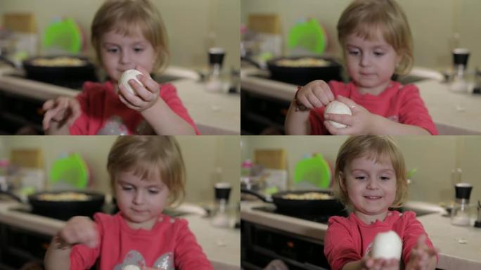 一个小女孩的特写镜头用煮熟的鸡蛋清洗外壳