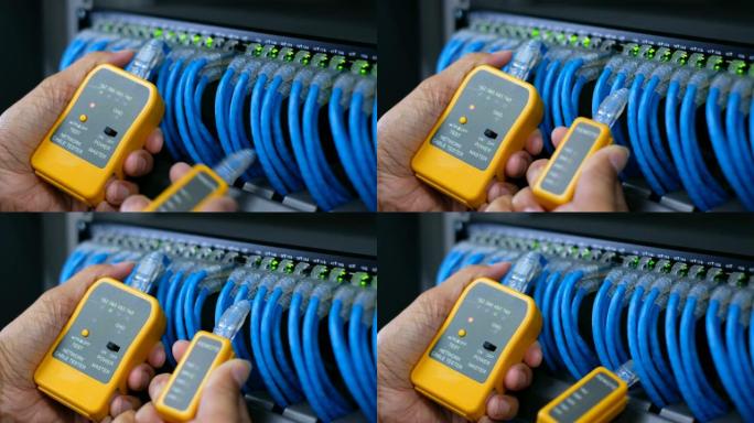 具有测试工具的系统管理员或技术人员，用于测试连接到网络数据中心网络千兆交换机接线板的网络电缆