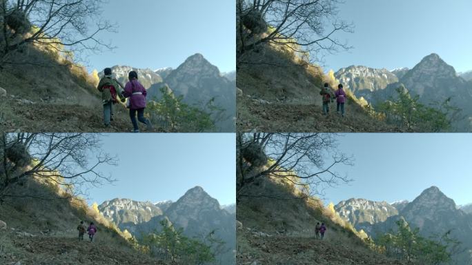 藏族男孩牵着女孩在山上奔跑