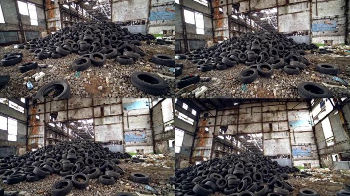 旧工厂内许多废旧橡胶轮胎躺在地上。