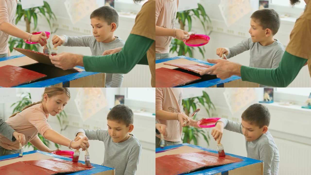 儿童用红色和蓝色油漆粉刷纸箱