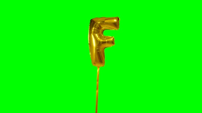 字母F来自漂浮在绿色屏幕上的字母氦气金气球