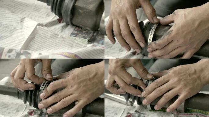 在汽车修理厂工作的男机械师。