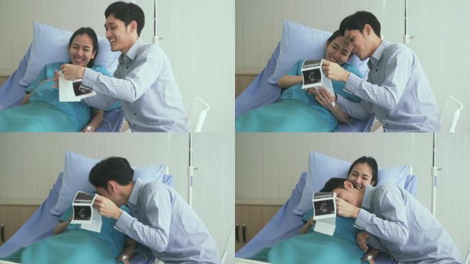 多莉在正面拍摄: 年轻的丈夫和怀孕的妻子在超声图像上看到他们的孩子时的幸福时刻