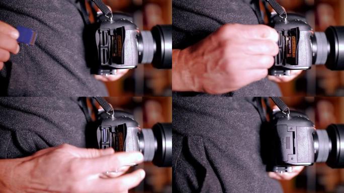 一个人的手将sd卡插入DSLR相机，无反光镜相机，摄影和摄影使用，摄像设备
