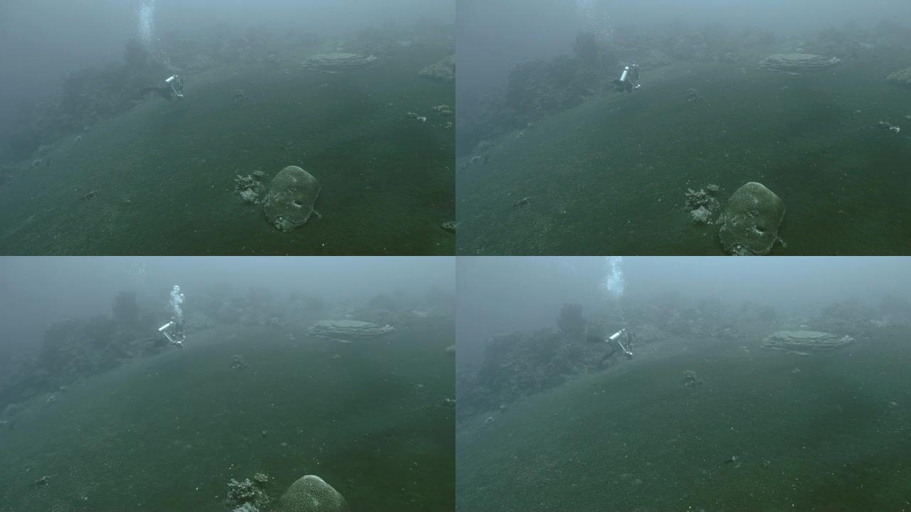 水肺潜水员在印度尼西亚的水下火山景观下游泳
