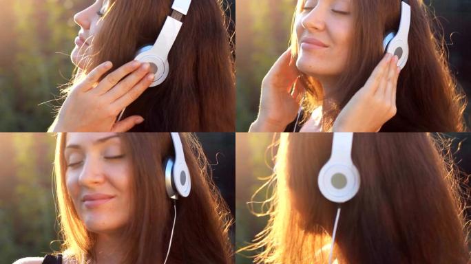 女人戴着耳机听音乐，闭着眼睛在户外日落时带着阳光。一个美丽的特写女孩的肖像。